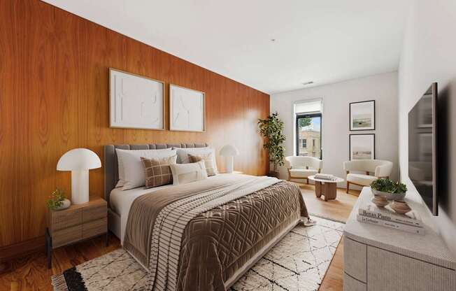 A bedroom with a large bed and a flat screen TV.