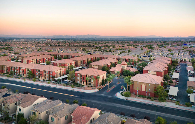 an aerial view of a city with houses and an intersection