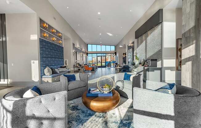 A modern living room with a large grey sofa and a coffee table.