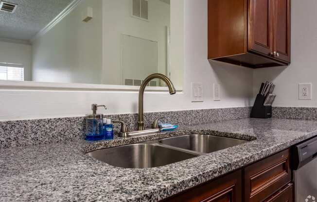 a kitchen with granite counter tops and a sink