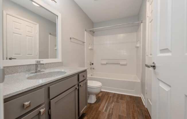 A bathroom with a toilet, sink, and bathtub.