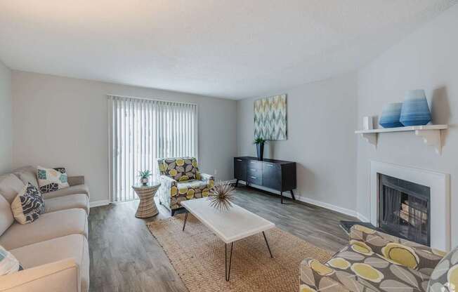 A living room with a fireplace and a television.