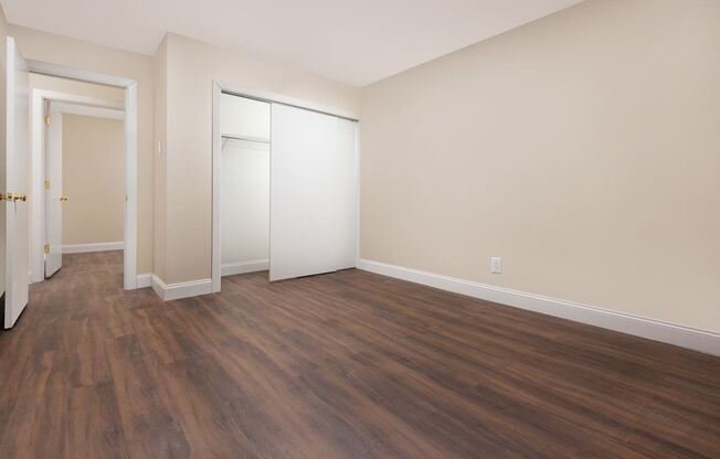 A room with wooden floors and white walls.