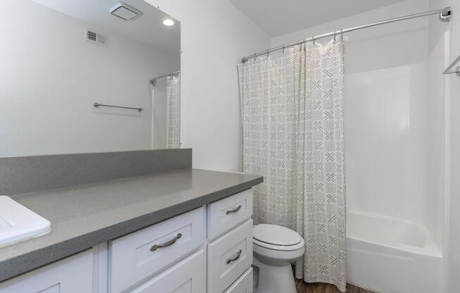 a white sink sitting next to a shower