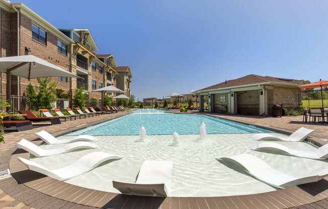 the preserve at ballantyne commons pool with lounge chairs and building with water feature