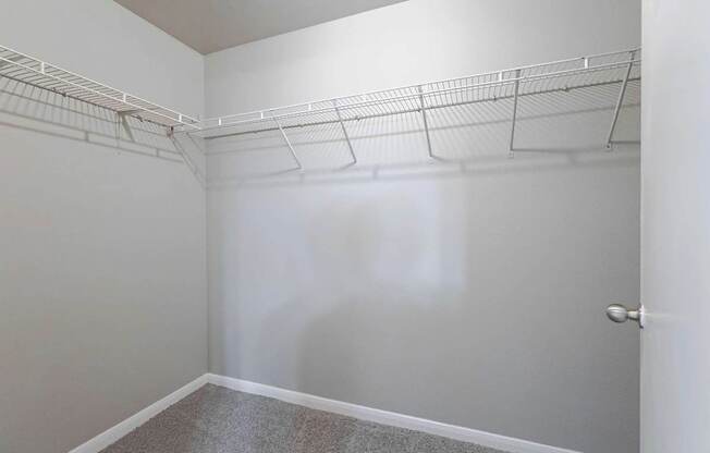 Empty room with white walls and a door on the right.