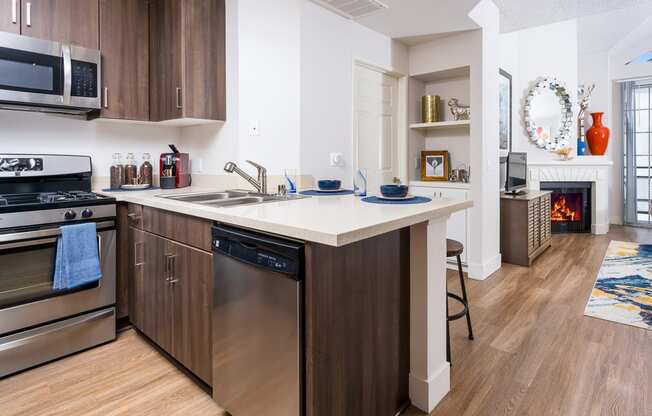 a kitchen with an island and a stove and a fireplace