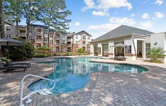 a swimming pool with an apartment building in the background