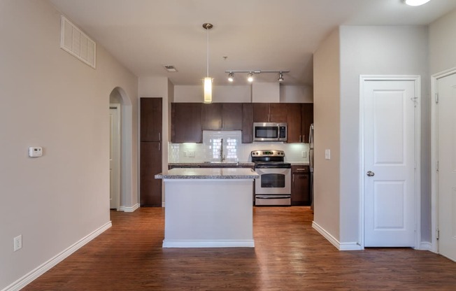 an empty kitchen with an island in the middle