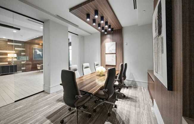 A conference room with a long table and chairs.