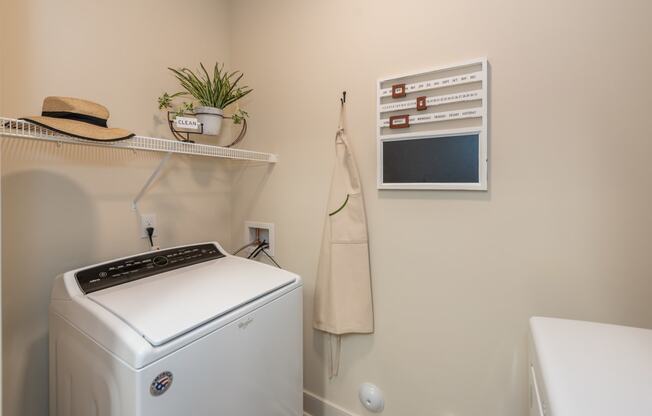 a laundry room with a washer and dryer at The Bend Arbordale, Williamsburg, VA
