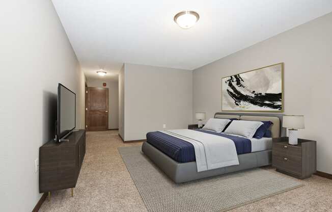 Georgetown on the River Apartments, Fridley, Minnesota. A bedroom with a bed and a tv.