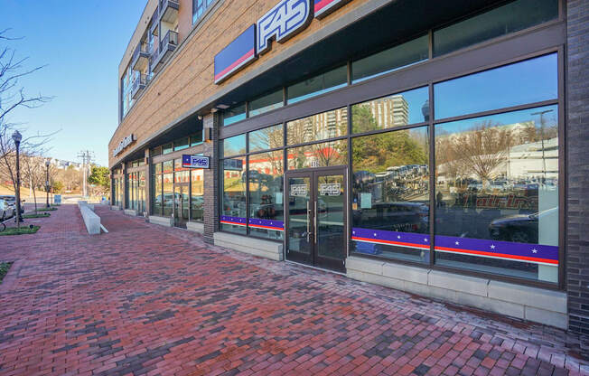 the facade of a store on a brick sidewalk