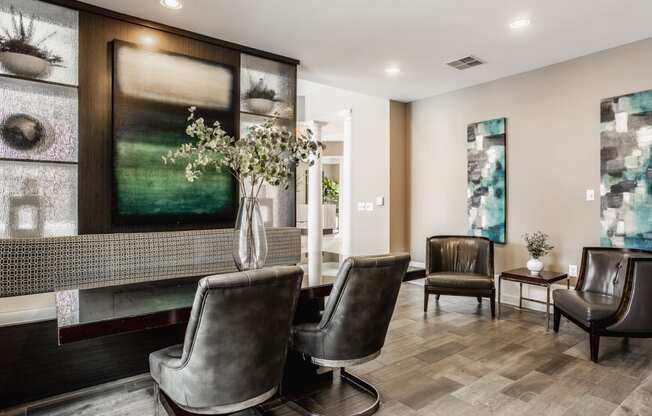 a living room with leather chairs and a fireplace