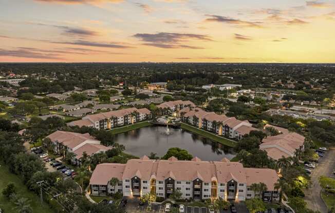 an aerial view of a community with a lake and residential buildings