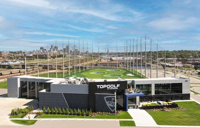 a rendering of a dealership with a city in the background