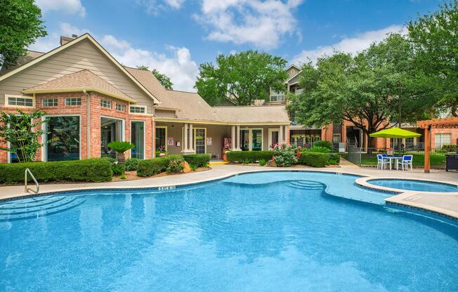 A serene backyard scene featuring a sparkling blue swimming pool surrounded by lush greenery and colorful flowers. In the background, a well-designed house with large windows complements the inviting outdoor space, which includes seating areas and an umbrella-shaded table. The sky is bright and partly cloudy.