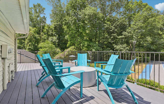 A set of six chairs and a table are on a deck at Gwinnett Square Apartments in Duluth, GA
