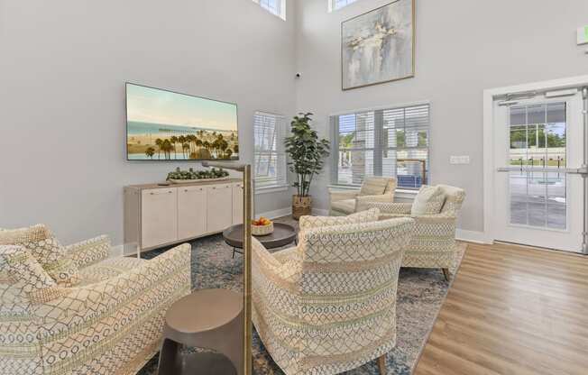 the living room of a house with chairs and a table