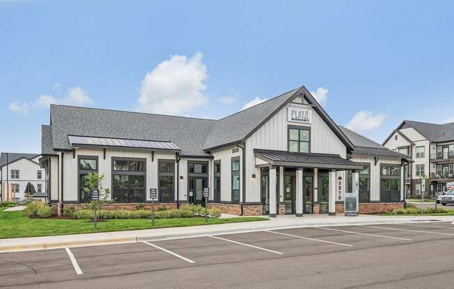 a building with a parking lot and a street in front of it