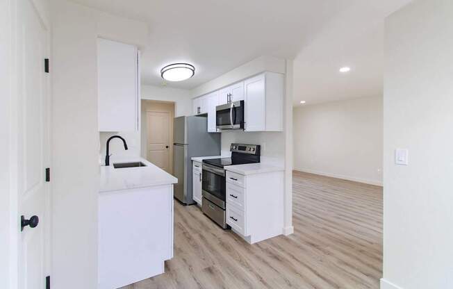 Modern kitchen with black range and white cabinetry in Redmond, WA apartments for rent