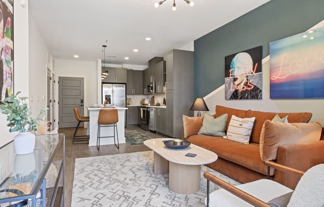A modern living room with a brown sofa and a glass table.