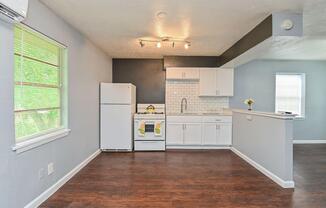 a kitchen area with a building in the background