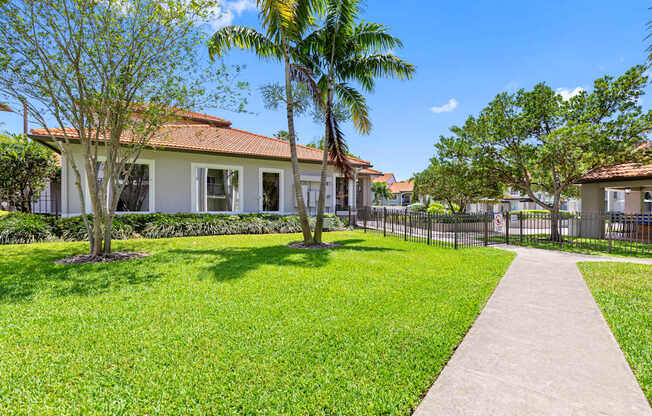 A house with a red roof and a white fence.