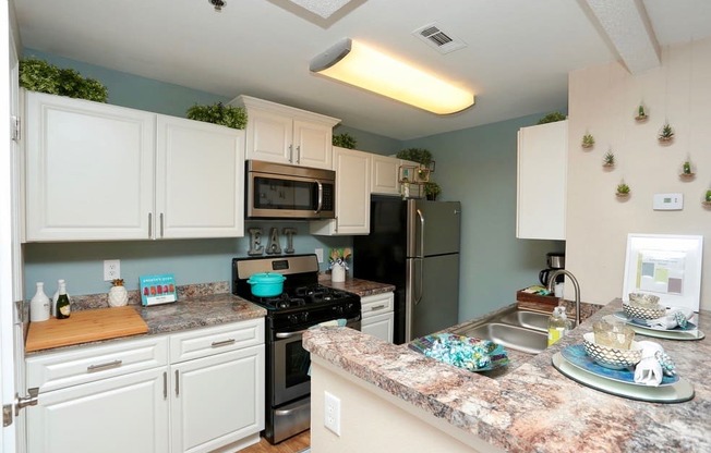 a kitchen with stainless steel appliances and granite counter tops