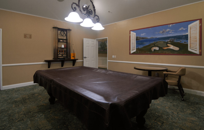 A room with a bed, a chair, and a painting on the wall.,A room with a bed, a chair, and a painting on the wall.