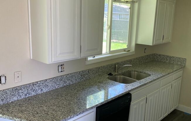 4 Bedroom, 2 Bathroom House with Large Fenced Backyard, New Vinyl Plank Flooring, Granite Countertops and Updated Bathroom with New Surround