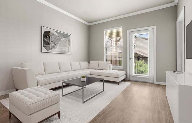 A modern living room with a white sofa, a coffee table, and a white ottoman.