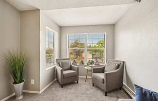 A sunny room with two chairs and a table.