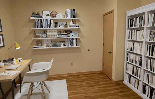 a room with a desk and a bookshelf