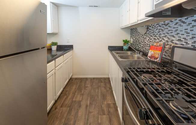 a kitchen with stainless steel appliances and a stove top oven