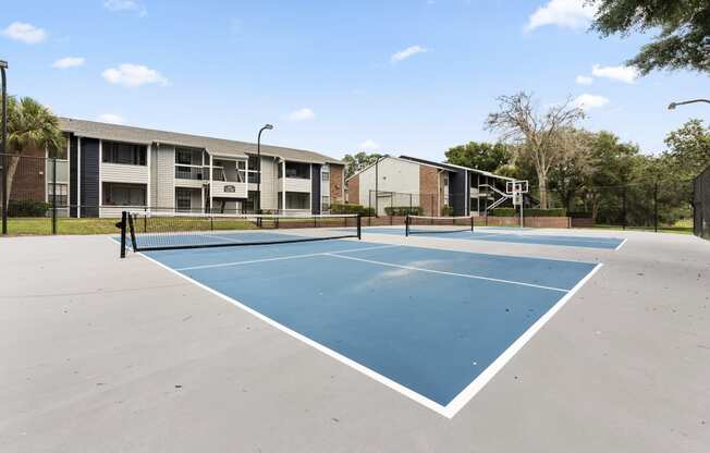 the tennis courts at the whispering winds apartments in pearland tx