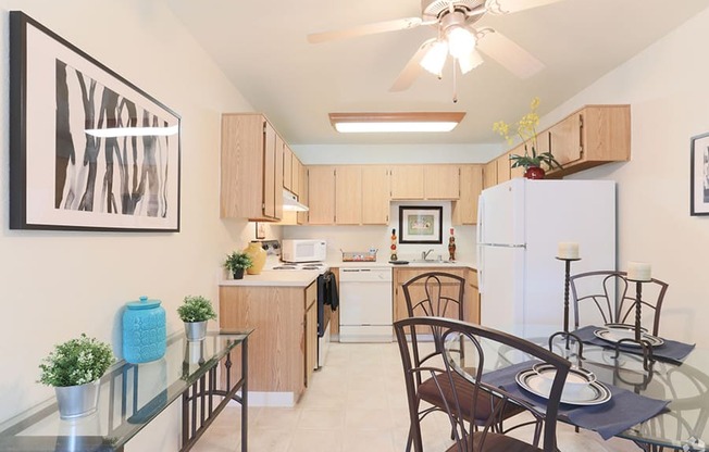 Ashford park kitchen and dining area with ceiling fan and light colored cabinets