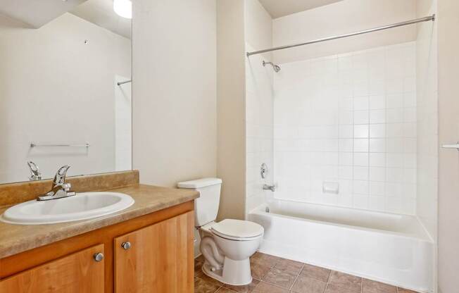 A bathroom with a sink, toilet, and bathtub.