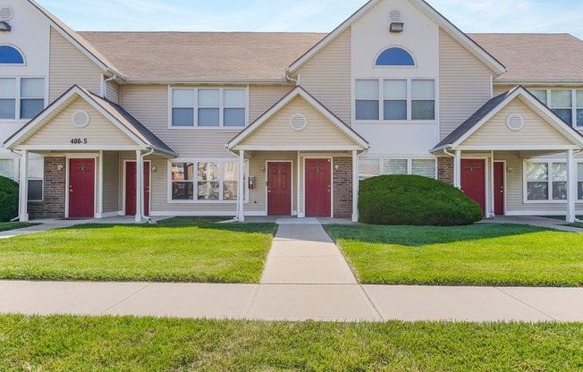 Lush Grass Area In Front Of Apartment Homes With Private Entrances