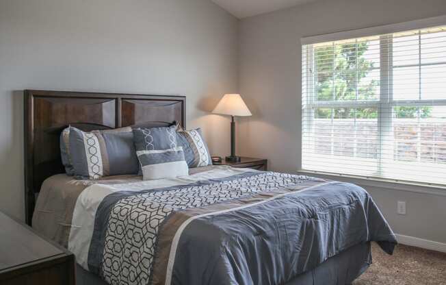 a bedroom with a large bed and oversized window at Village at Cottonwood Springs in El Paso