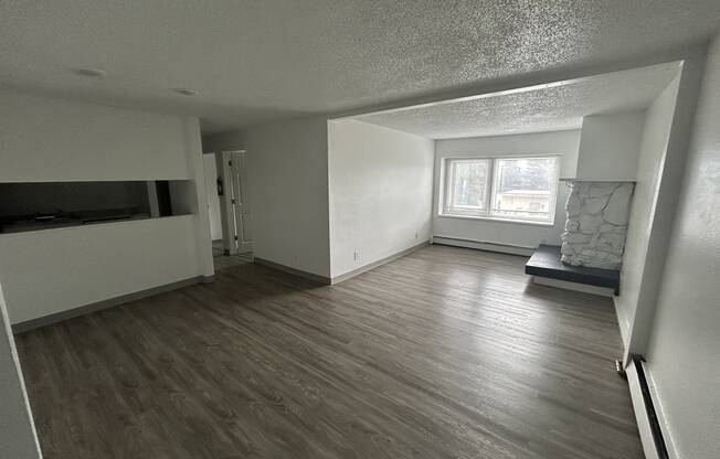 an empty living room with wood flooring and a window at Kings Court, Anchorage, AK ? 