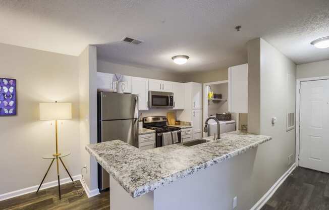 a kitchen with a granite counter top and stainless steel appliances