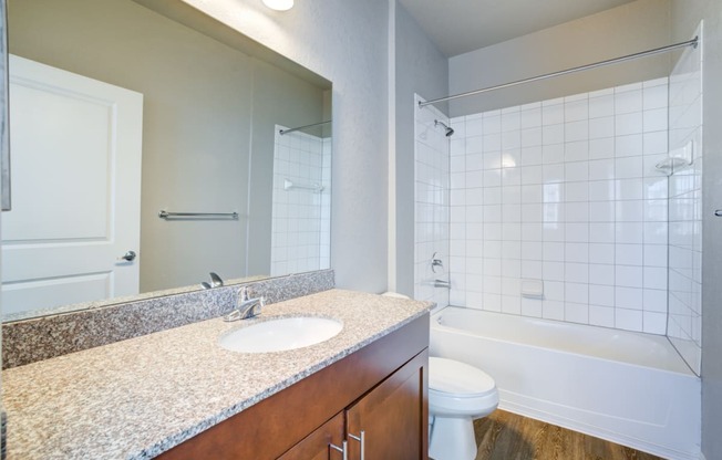 a bathroom with a toilet sink and shower