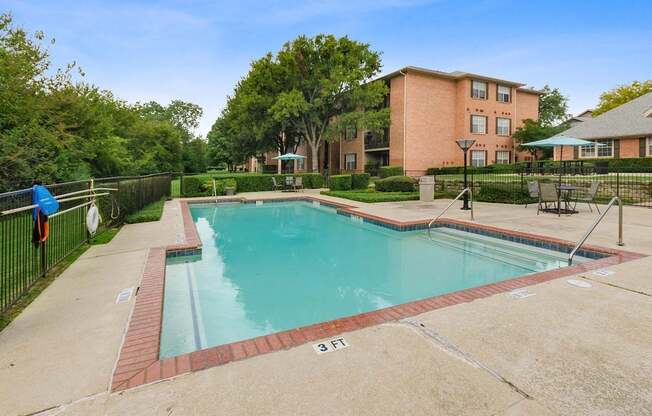 A swimming pool surrounded by a brick border with a number 3 on it.