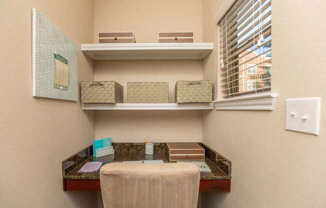 A bathroom with a toiletries organizer and a towel on a table.