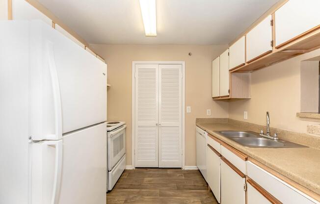 a kitchen with a sink and a mirror