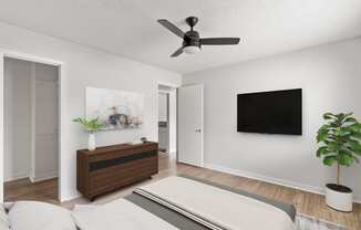 a living room with a ceiling fan and a bed