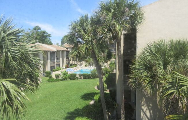 Sandy Cove 1 bedroom top floor condominium  unit with screen porch and  pool view