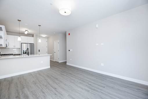 A kitchen area with a counter and cabinets.