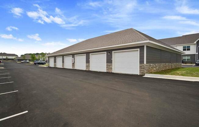 A large garage with a stone pillar in front of it.